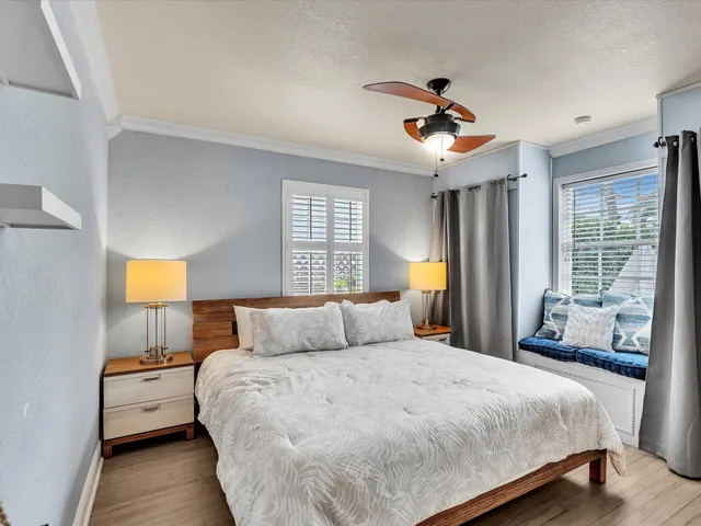 a bedroom with a bed and a view of living room
