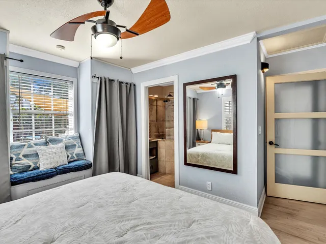 a bathroom with a granite countertop sink a toilet and shower