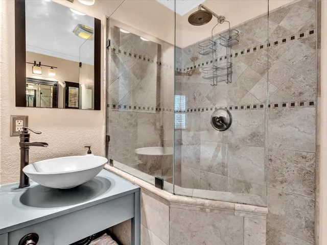 a bedroom with two beds and a large mirror