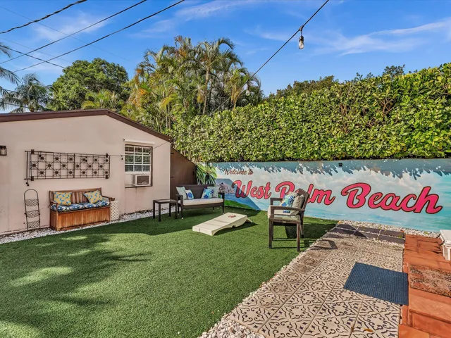 a view of a backyard with sitting area