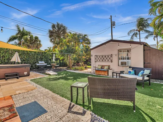 a patio with sofas table and chairs