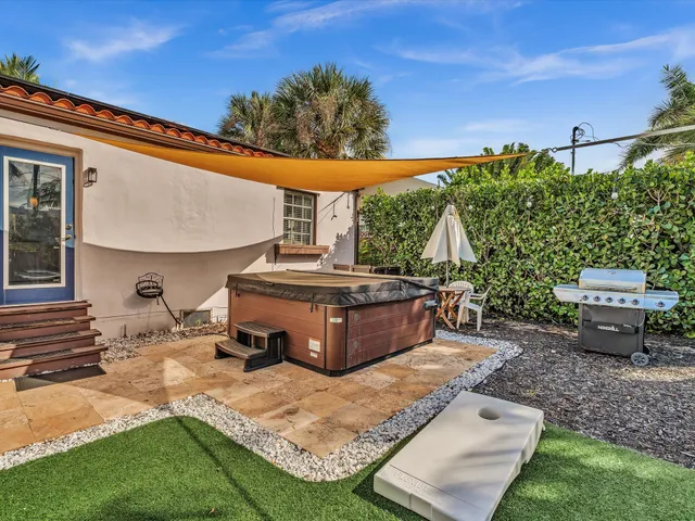a view of a backyard with sitting area