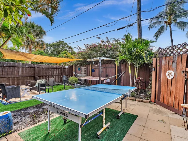 front view of a house with a yard and potted plants