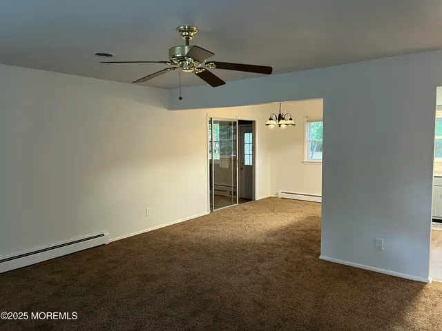 a view of empty room with a fan