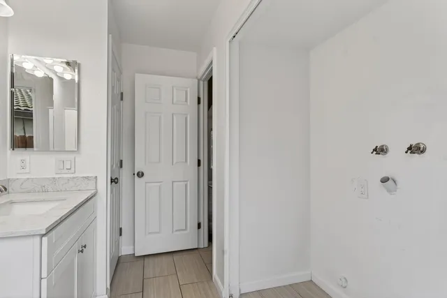 a kitchen with stainless steel appliances granite countertop a stove top oven a sink and a refrigerator