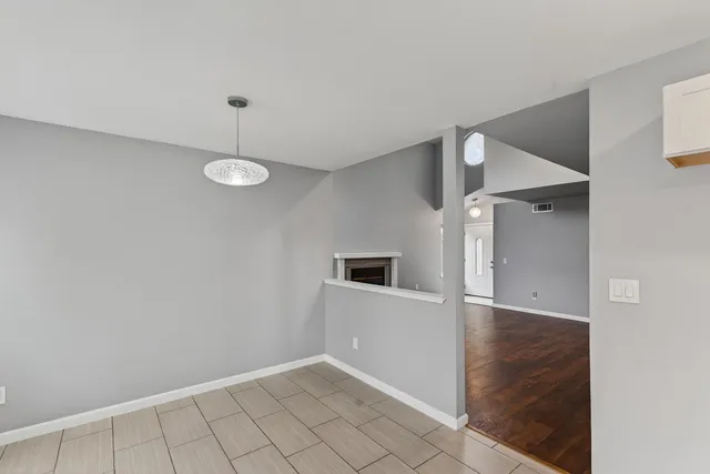a kitchen with white cabinets and appliances