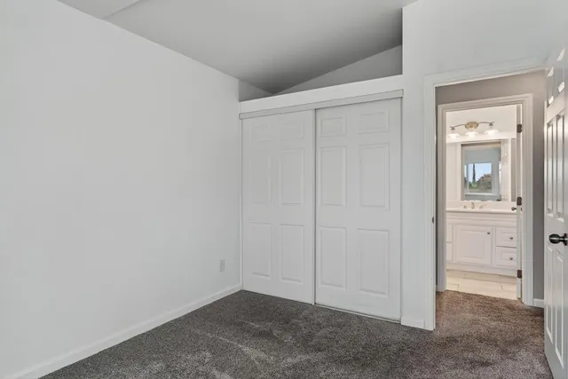 a view of staircase with railing and white walls