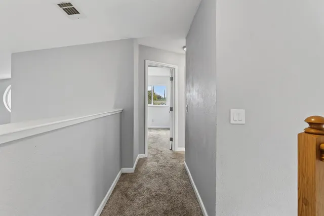 a view of a house with backyard and tree