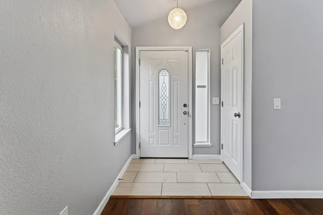 a view of a hallway with wooden floor