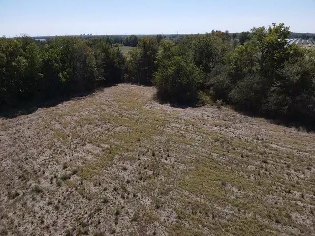 a view of a covered with trees in the background
