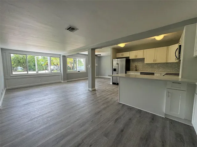 a kitchen with stainless steel appliances a refrigerator sink and cabinets
