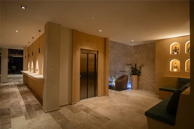 a view of a hallway with furniture and window