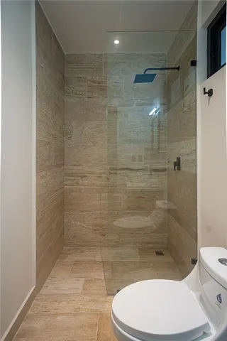 a bathroom with a toilet and a shower
