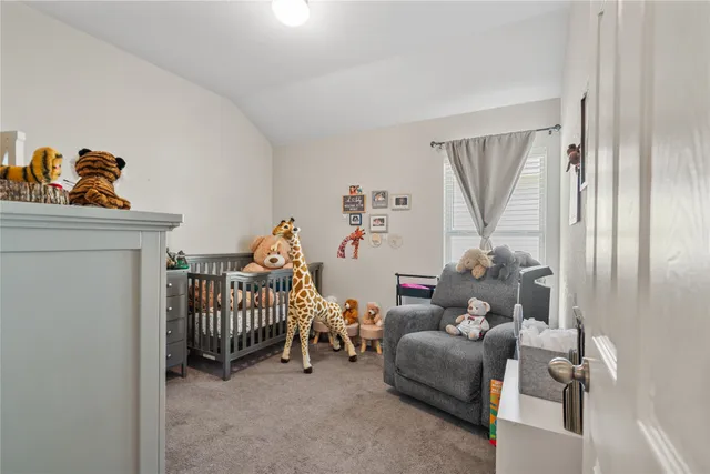 a bedroom with furniture and a baby crib