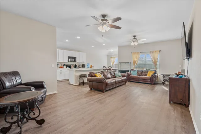 a living room with furniture and a chandelier