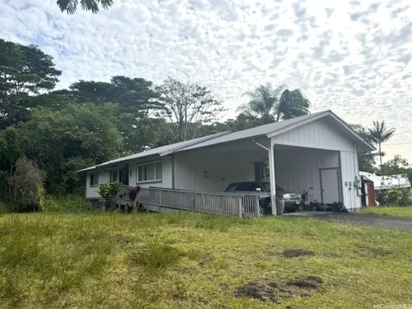 a front view of house with yard and seating area