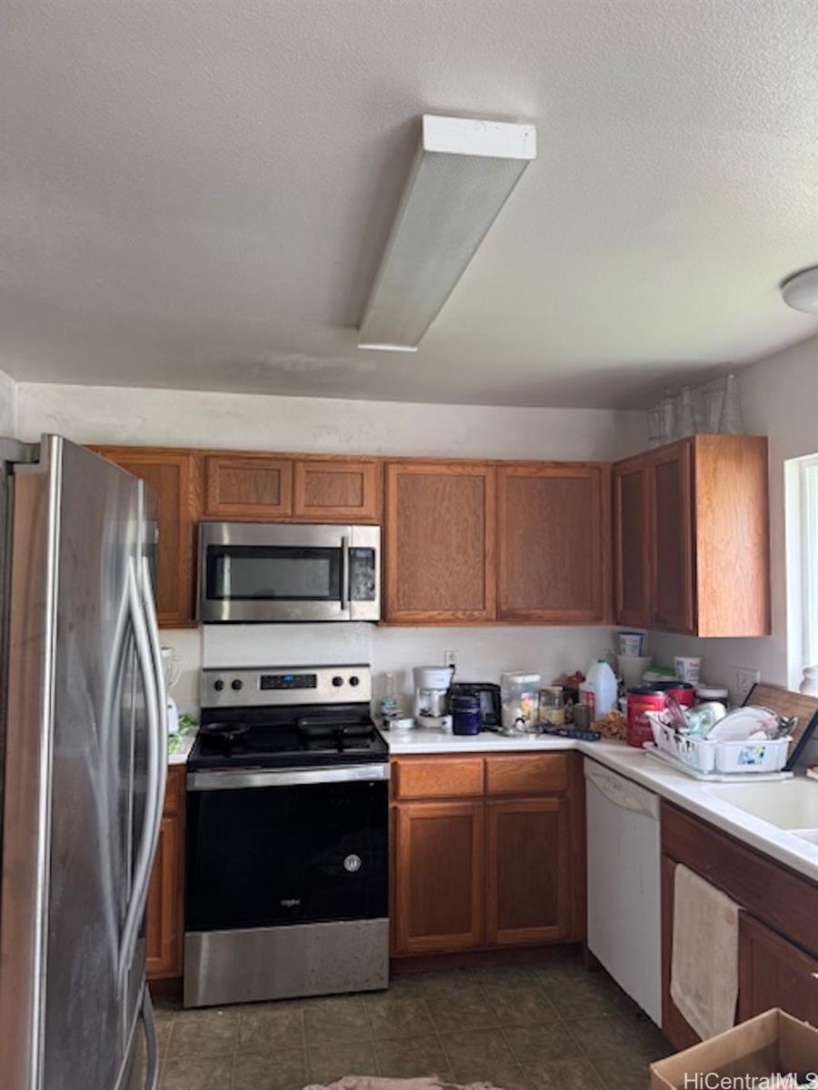 101 Kilua Road Hilo, HI 96720 - Photo 4 of 7 a kitchen with a sink stove and refrigerator