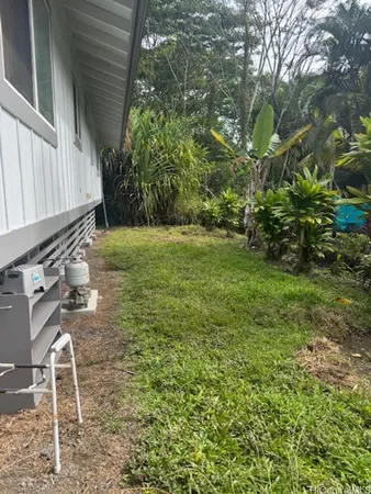 a backyard of a house with table and chairs