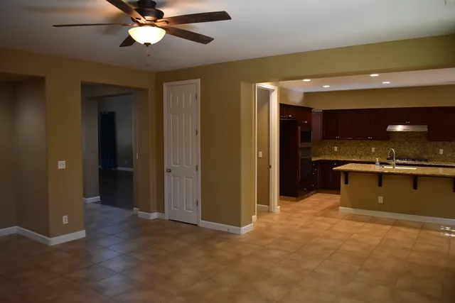 a view of a kitchen with a sink and a refrigerator