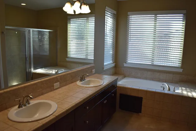 a bathroom with a double vanity sink and a mirror
