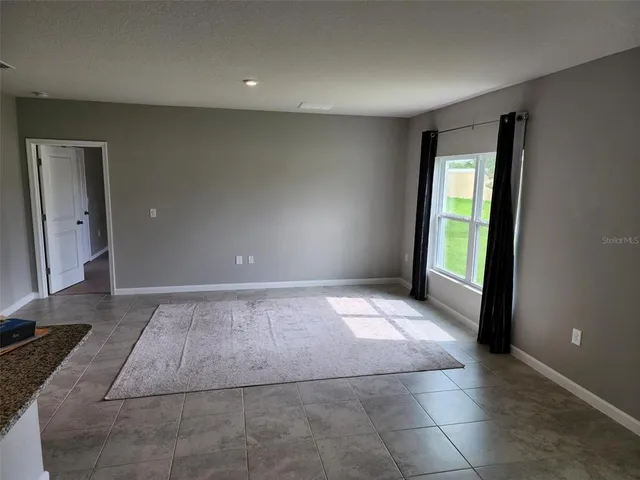 a kitchen with granite countertop a refrigerator and a sink