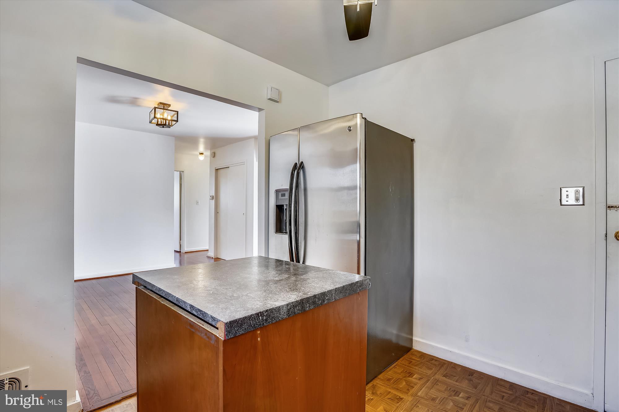 1010 Crosby Road Baltimore, MD 21228 - Photo 12 of 47 a view of kitchen island with furniture and wooden floor