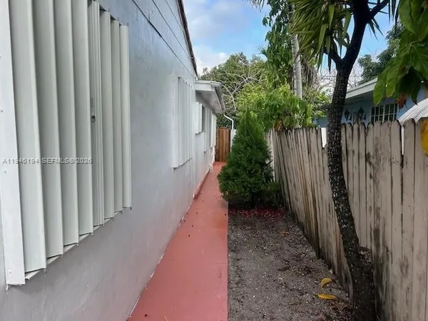 a view of a pathway with a wooden fence