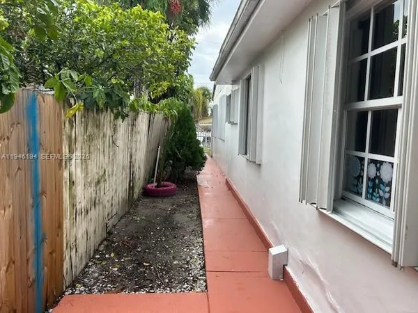 a view of balcony with wooden floor and fence