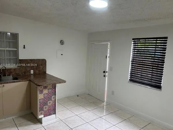 a kitchen that has a sink and a stove