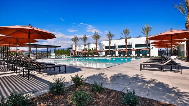 a view of a lake with a table and chairs under an umbrella
