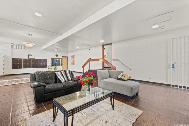 a living room with furniture and kitchen view