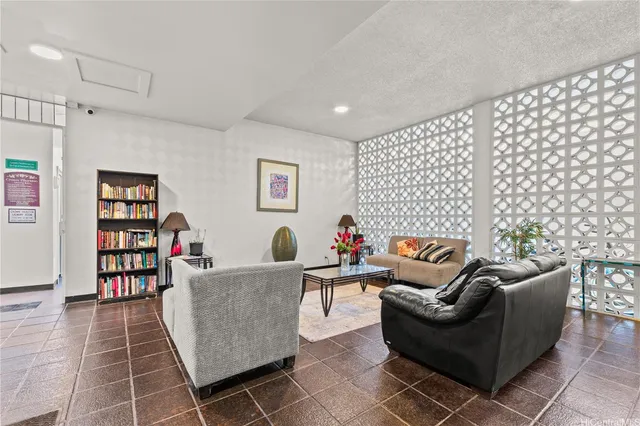 a living room with furniture and a book shelf