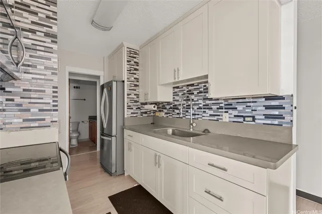 a kitchen with a sink and refrigerator