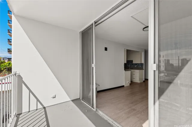 a view of a hallway with a kitchen space