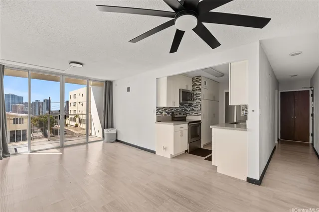a view of a kitchen and an empty room