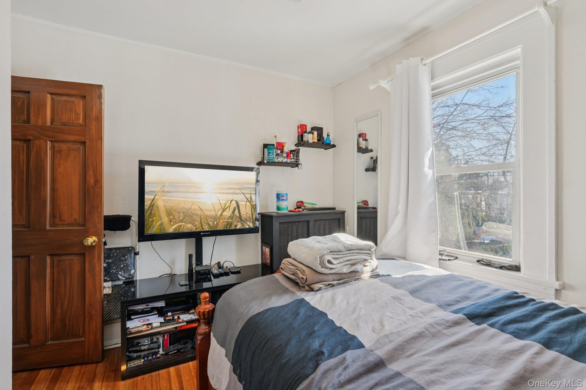 30 Ferdinand Place New Rochelle, NY 10801 - Photo 17 of 46 a bedroom with a bed and a flat screen tv
