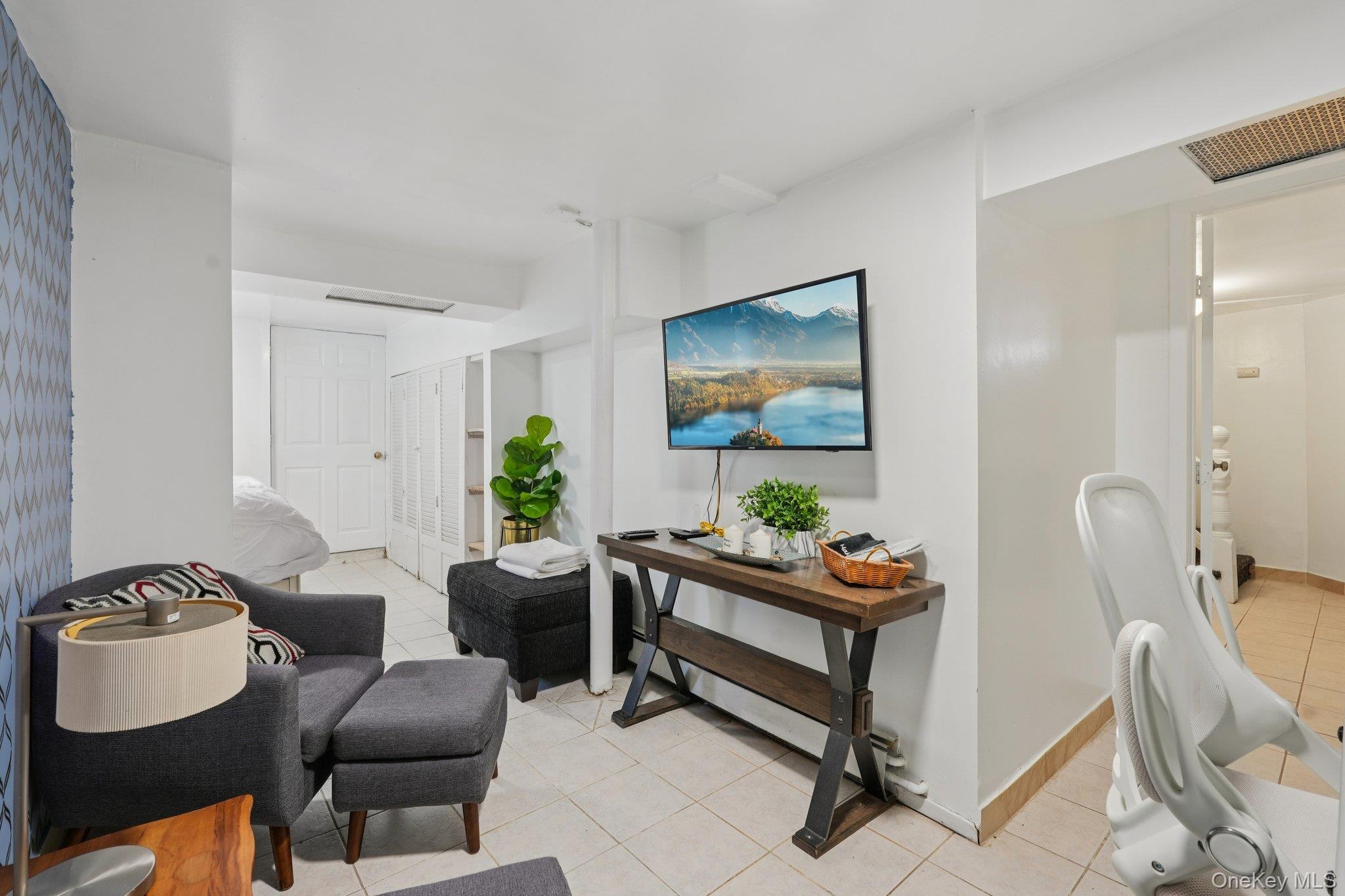 30 Ferdinand Place New Rochelle, NY 10801 - Photo 23 of 46 a living room with furniture and a flat screen tv