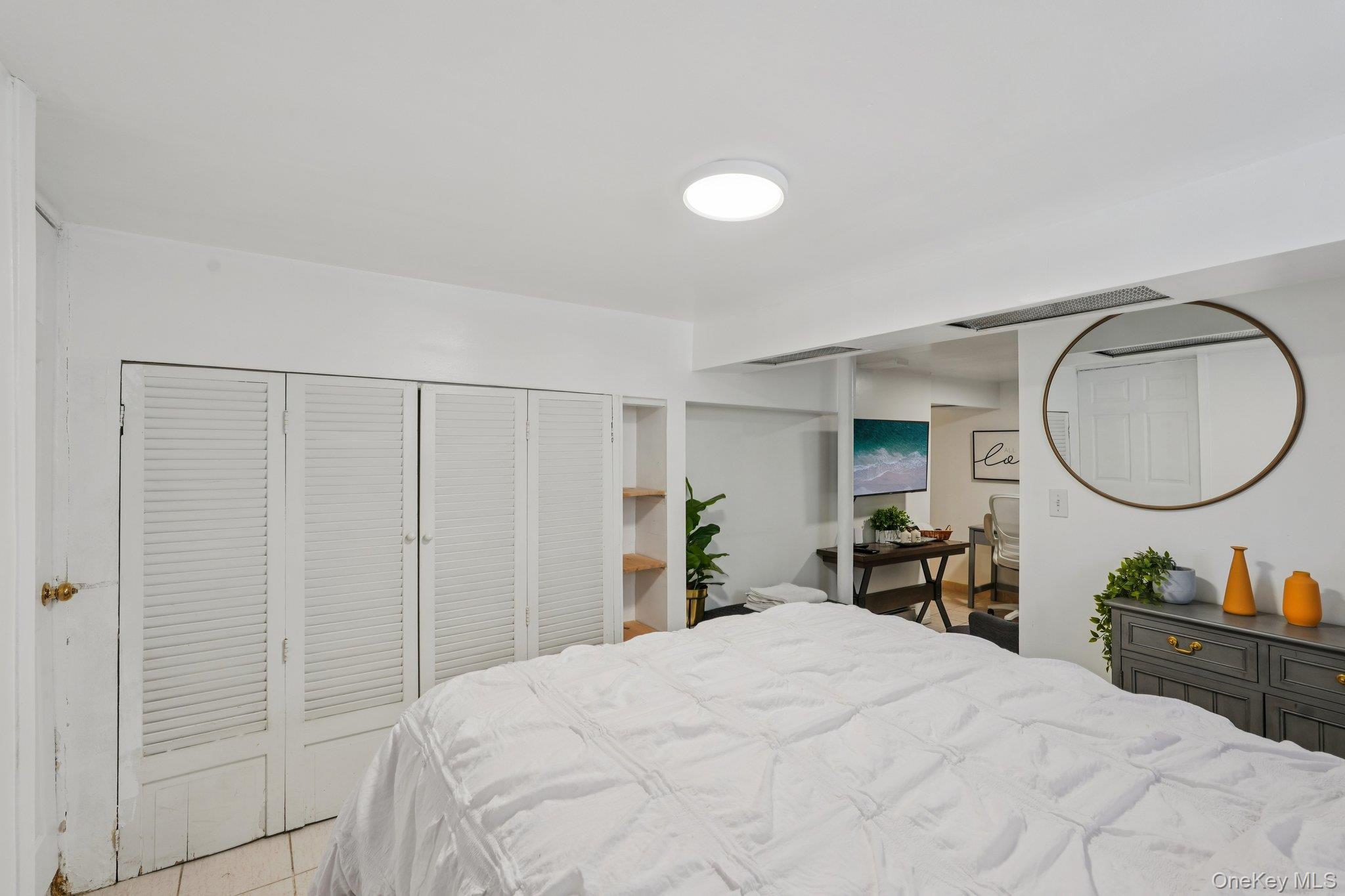 30 Ferdinand Place New Rochelle, NY 10801 - Photo 28 of 46 a bed room with a bed mirror and a chair