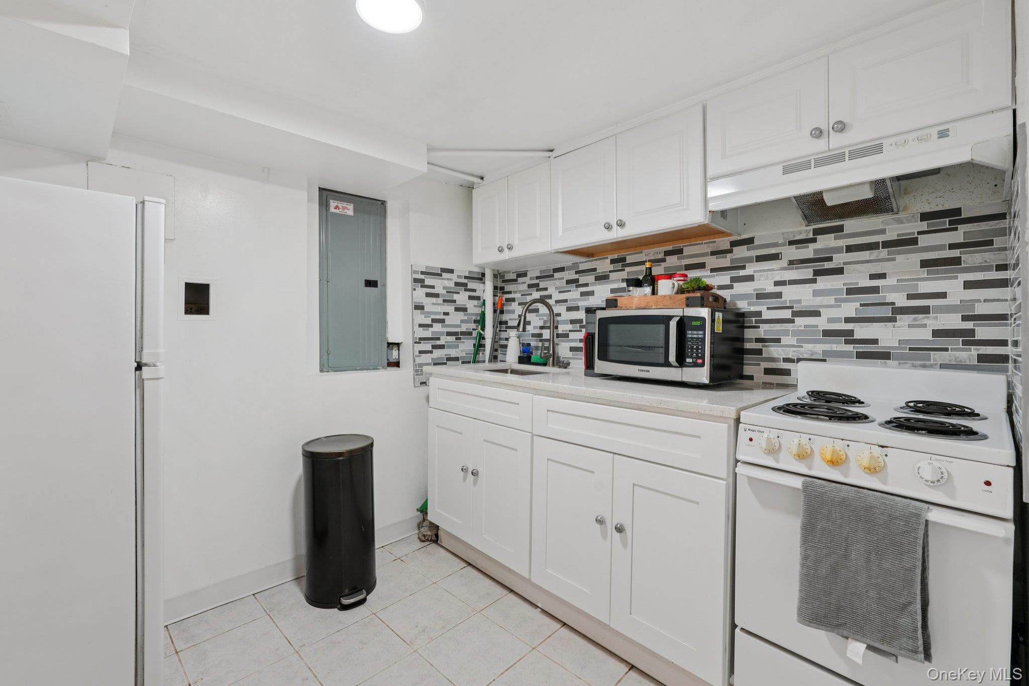 30 Ferdinand Place New Rochelle, NY 10801 - Photo 30 of 46 a kitchen with white cabinets and white appliances