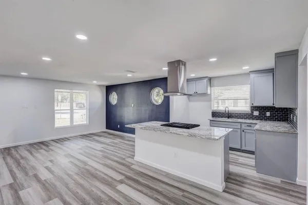 a kitchen with stainless steel appliances granite countertop a stove and a sink