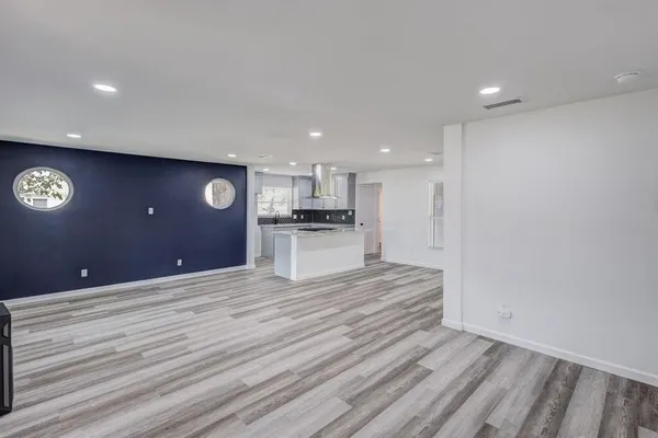 a view of kitchen with refrigerator microwave and cabinets