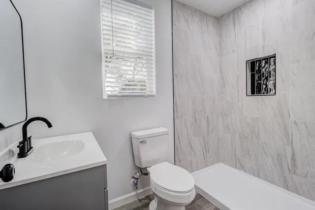 a white toilet sitting next to a bathroom sink