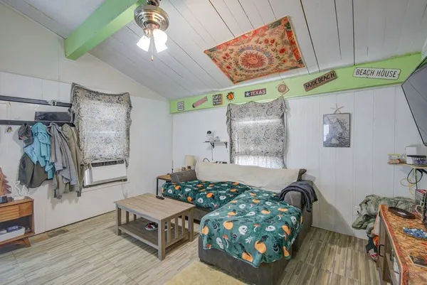 a bed sitting in a bedroom next to a window