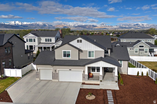 11694 Engelmann Drive Draper, UT 84020 - Photo 41 of 41 View of front of home featuring a porch, a residential view, concrete driveway, stucco siding, and a mountain view