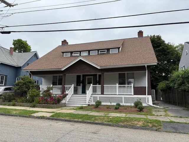 a front view of a house with a yard table and chairs