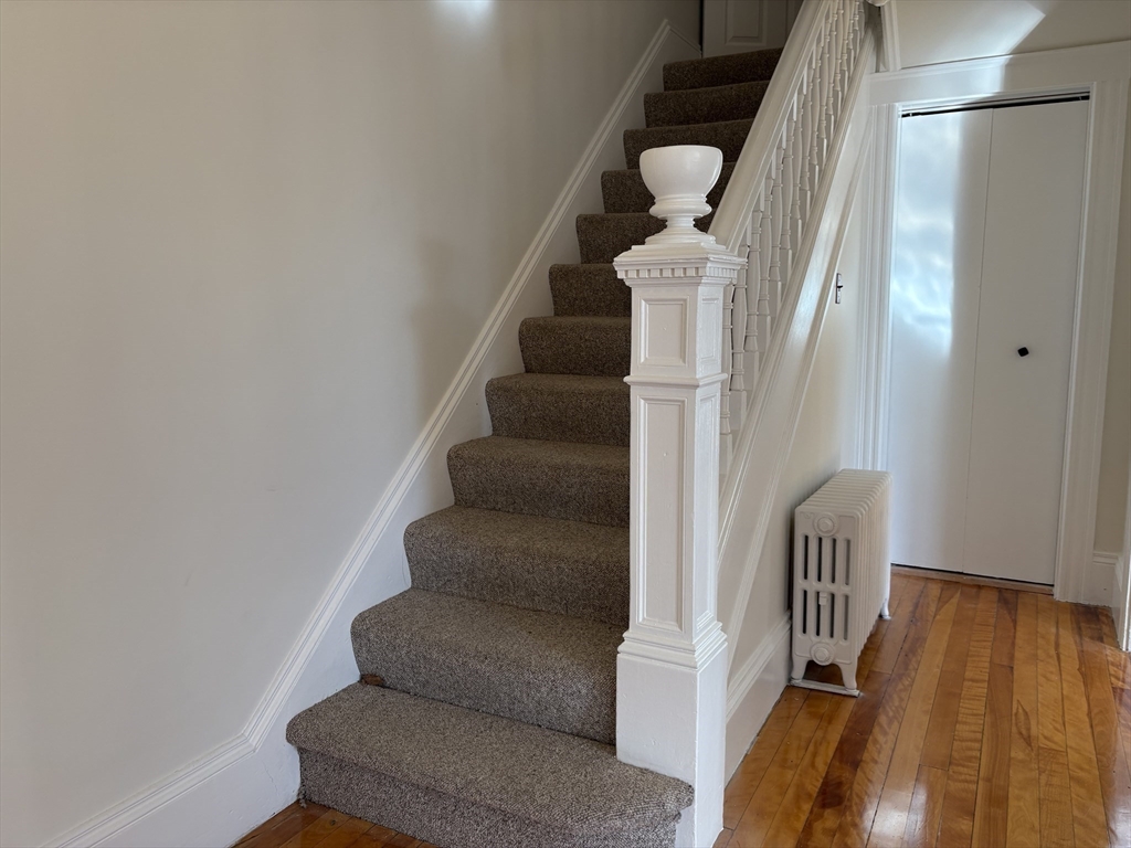 57 Coburn Avenue, Unit 2 Worcester, MA 01604 - Photo 18 of 42 a view of staircase with wooden floor and white walls