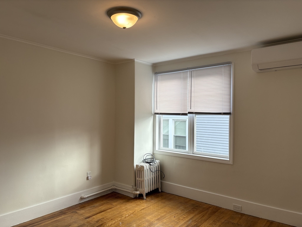 57 Coburn Avenue, Unit 2 Worcester, MA 01604 - Photo 23 of 42 an empty room with wooden floor and windows