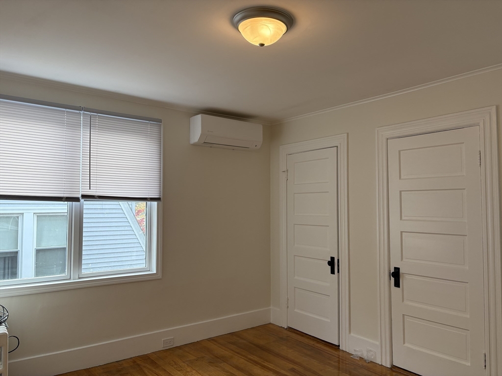 57 Coburn Avenue, Unit 2 Worcester, MA 01604 - Photo 24 of 42 an empty room with wooden floor and windows