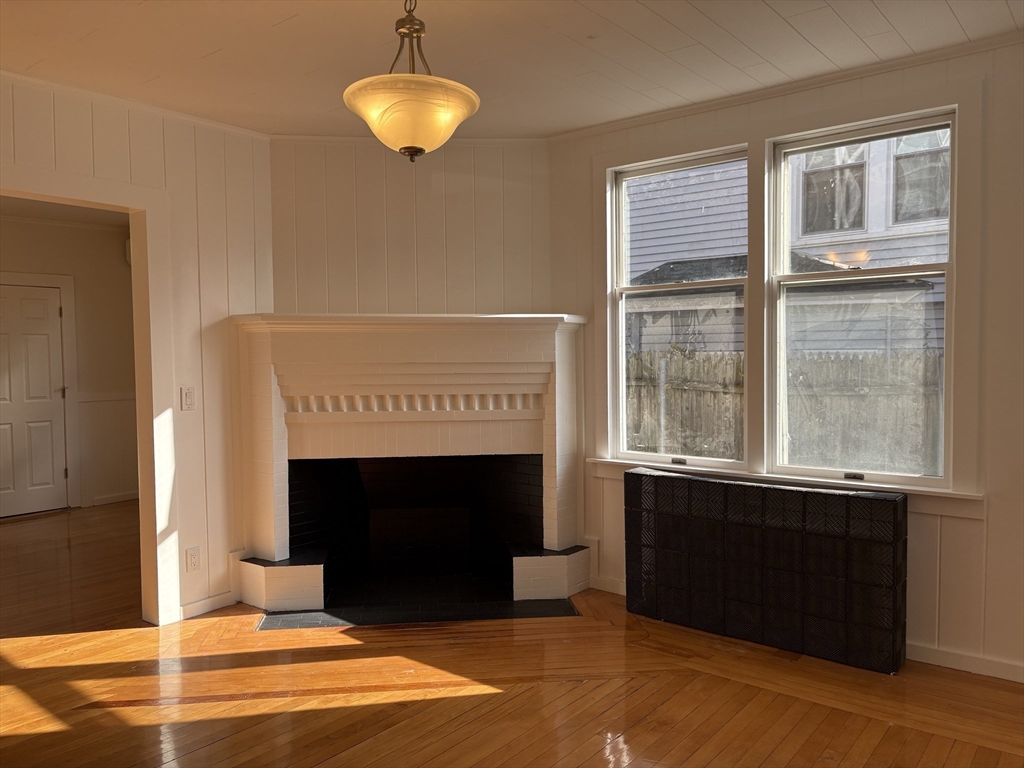 57 Coburn Avenue, Unit 2 Worcester, MA 01604 - Photo 3 of 42 a living room with a fireplace and a large window