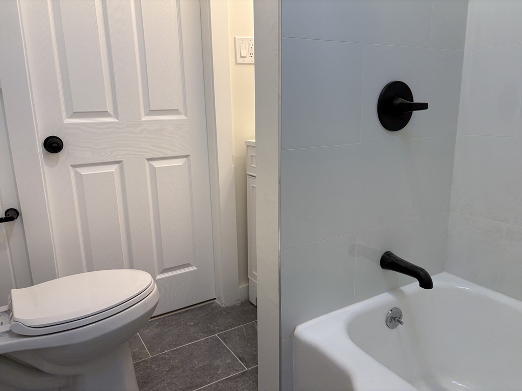 57 Coburn Avenue, Unit 2 Worcester, MA 01604 - Photo 32 of 42 a bathroom with a sink and a toilet